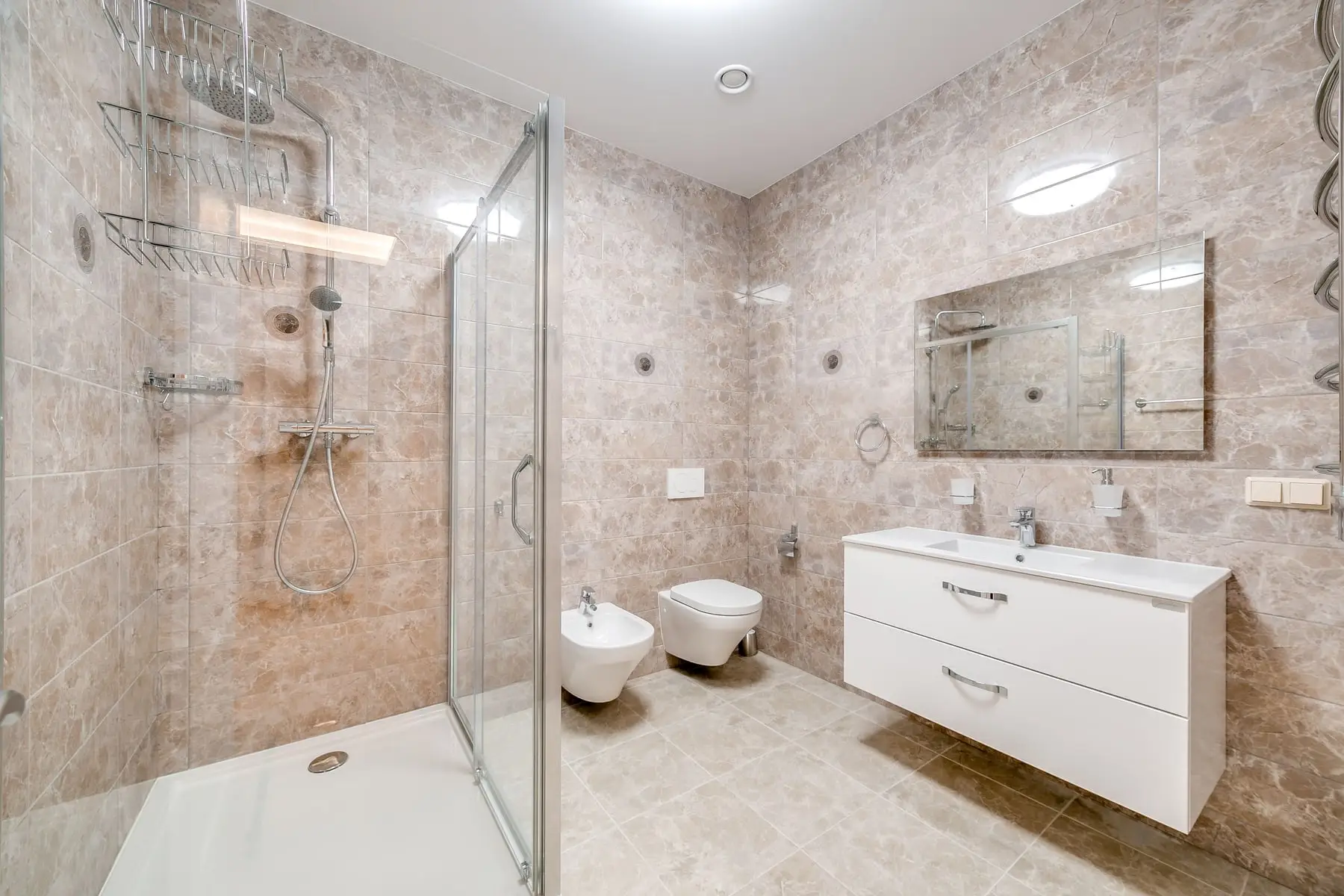 A renovated unit bathroom with shower and wall-hung vanity